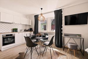 a kitchen and dining room with a table and chairs at Einzimmerwohnung in Seenähe klimatisiert in Friedrichshafen +6 photos
