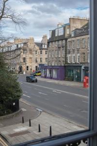 a view from a window of a street with buildings at Magnificent Georgian 3-Bedroom Apartment in New Town in Edinburgh