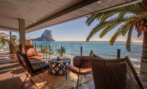 a room with a view of the beach and the ocean at ESTIMAR Calpe Apartments in Calpe