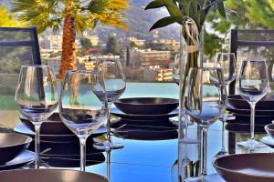 a table with wine glasses on a table with a view at La Villa Gairaut in Nice