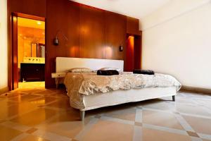 a bedroom with a bed with a wooden wall at La Villa Gairaut in Nice