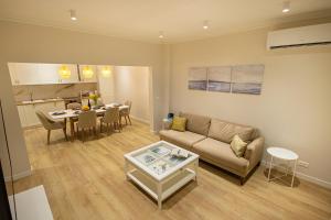 a living room with a couch and a table at Grand Relax Cape Cod by RV Apartments in Varna City