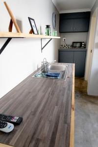 a kitchen with a sink and a wooden counter top at Mulkana in Bloemfontein