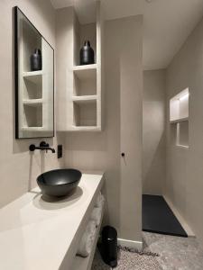 a bathroom with a black bowl sink on a counter at 3 Bedroom Art-Nouveau Apartment with Free Parking in Ghent