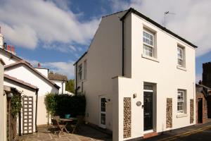 a white house with a black roof at Mulberry Cottage - Cosy 3 Bed Cottage near Lytham Windmill in Lytham St Annes