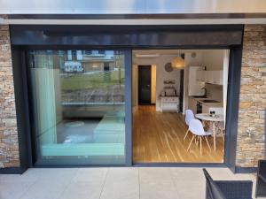 a sliding glass door leading to a kitchen and dining room at Molo Lipno in Lipno nad Vltavou