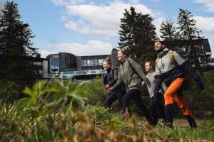 a group of people walking through a field at Break Sokos Hotel Koli in Kolinkylä