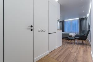 a room with a door leading to a bedroom at Shades of gray - NEW DELUX Apartments in Kyiv
