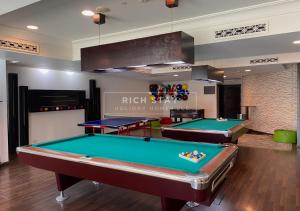 a billiard room with two pool tables in it at Sensational 1BR apartment in Tajer, Souk Al-Bahar in Dubai