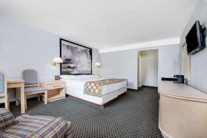 a hotel room with a bed and a tv at Super 8 by Wyndham Niagara Falls North in Niagara Falls