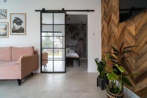 a living room with a couch and a sliding glass door at Apartament J&T Mrągowo in Mrągowo