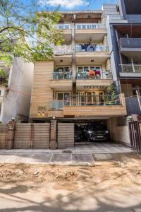 a building with a car parked in front of it at Homlee-Basement Flat with kitchen in Saket, South Delhi in New Delhi