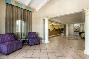 a lobby with purple chairs and a waiting room at La Quinta Inn Tampa Airport Stadium Westshore in Tampa