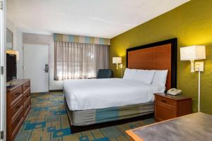 a hotel room with a large bed and a television at La Quinta Inn Tampa Airport Stadium Westshore in Tampa
