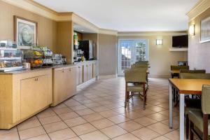 a kitchen and dining room with a table and chairs at La Quinta Inn Tampa Airport Stadium Westshore in Tampa
