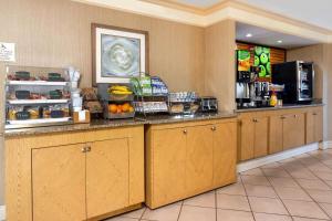 a breakfast counter in a hotel room with food at La Quinta Inn Tampa Airport Stadium Westshore in Tampa