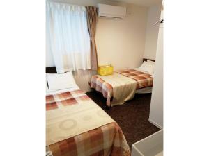 a hotel room with two beds and a window at Tokyo stay Hut SARI - Vacation STAY 27239v in Tokyo