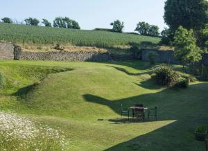 a picnic table in the middle of a field at Rame Barton Guest House and Pottery in Cawsand