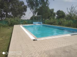 a swimming pool in the backyard of a house at Braj Waterpark & Resort in Kannauj