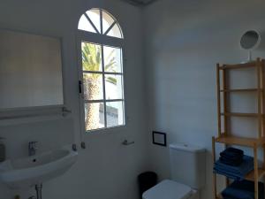 a bathroom with a sink and a window at Wohnung Sabina in Agüimes