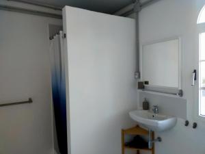 a bathroom with a sink and a mirror at Wohnung Sabina in Agüimes +11 photos
