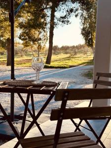 a table with a wine glass sitting on top of it at Agricampeggio La Piaggia - Agriturismo in Piombino