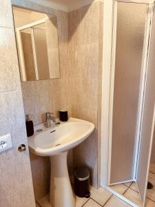 a bathroom with a sink and a shower at Agricampeggio La Piaggia - Agriturismo in Piombino