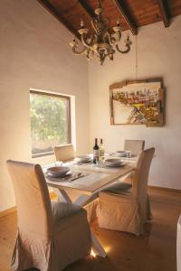 a dining room with a table with chairs and a chandelier at Casa Maja in Lajares