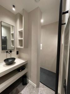 a bathroom with a sink and a mirror at 3 Bedroom Art-Nouveau Apartment with Free Parking in Ghent