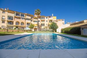 a swimming pool in front of a building at Erisa 55 by IVI Real Estate in Torremolinos