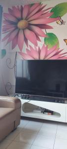 a flat screen tv sitting on top of a table at Homestay nipah in Bayan Lepas