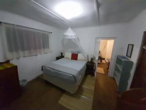 a bedroom with a bed and a light on the ceiling at Seaview Forest Cottage in Port St Johns