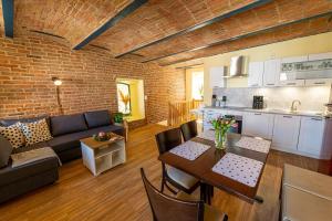 a kitchen and a living room with a couch and a table at Pension zur Postmeile in Bad Belzig