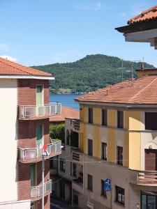 a view of some buildings with a river in the background at Casa Ierardi - Appartamento Meina in Meina