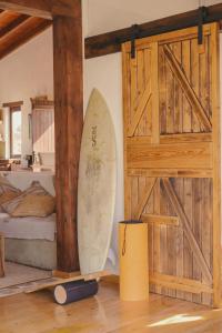 a surfboard leaning against a wall in a room at Casa Maja in Lajares +72 photos