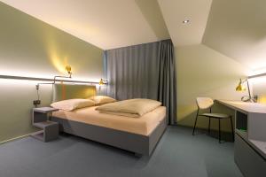 a hotel room with a bed and a desk at Landhotel Linde Fislisbach in Baden