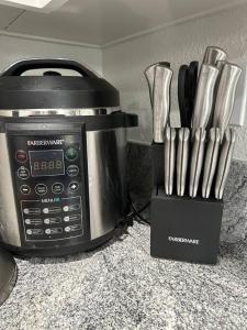 a kitchen counter with a toaster oven and a knife block at Cozy Getaway with King bed & 70inTV in Carmichael