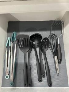 a drawer filled with utensils in a drawer at Cozy Getaway with King bed & 70inTV in Carmichael