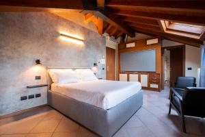 a bedroom with a bed and a desk and a chair at Antico Pozzo Apartment in Bellagio
