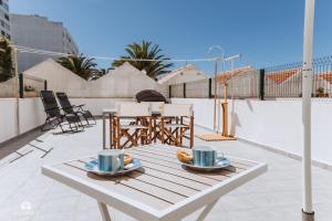 a table with two cups of coffee on a balcony at The Terrace - Santa Cruz in Santa Cruz