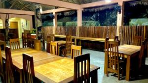 a dining room with wooden tables and chairs at VERONIKA Resort Nosy Komba in Nosy Komba