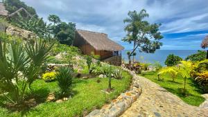 a path leading to a house with a garden at VERONIKA Resort Nosy Komba in Nosy Komba