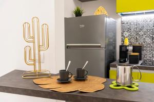 a kitchen with two coffee mugs on a counter at MINERVA LUXURY TOWN CENTER , POOL AND PARKING in Taormina
