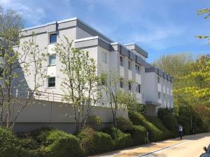 a white building with bushes in front of it at Ostseekrabbe in Timmendorfer Strand