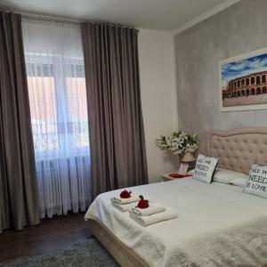 a bedroom with a bed with towels and a window at Appartamento Natalia Verona in Verona