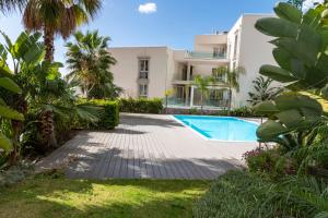 a villa with a swimming pool in front of a building at MINERVA LUXURY TOWN CENTER , POOL AND PARKING in Taormina