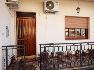 a house with potted plants in front of a door at casa vacanze Toto e Nina in Aradeo