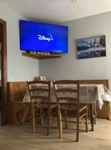 a living room with a table and a tv on a wall at Anayet Sweet Home in Formigal