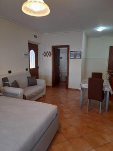 a living room with a bed and a couch and a table at Baita Mauri in Livigno