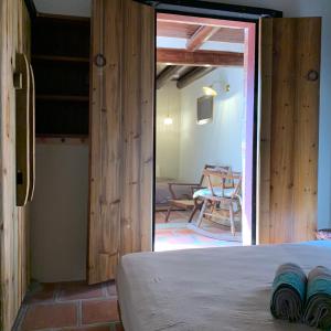 a room with a bed and a dining room with a table at Yamaharuka in Jinhu